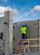 Working in a green jacket at a construction site