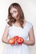 Girl with three apples in their hands