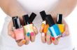 woman holding a bottle of nail polish