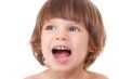 Studio portrait of a close-up of a girl with her mouth open with