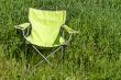 Green folding chair on the grass