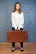 portrait of a beautiful girl with a suitcase
