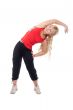 Beautiful girl in sportswear doing side bends.