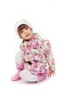 little girl in boots and a jacket sitting on the floor