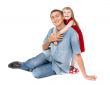 Smiling father and young daughter sitting on the floor