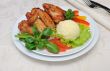 Baked chicken wings with garlic and potatoes and vegetables