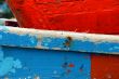 Peeling paint on rusted metal surface