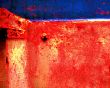 Peeling paint on rusted metal surface