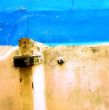 Peeling paint on rusted metal surface