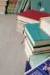A variety of books in stacks on the table