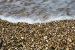 Pebbles on beach with sea wave 