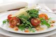 salad of arugula and cherry tomatoes with parmesan sauce
