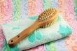 Wooden brush with the handle for massage of a body and a towel.