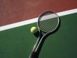 Tennis Ball with Racket on Court