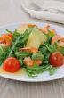 Spicy salad of arugula with cherry tomatoes and shrimp