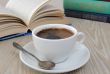 A cup of coffee on a table among books