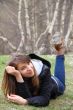 Young beautiful girl lying on the grass and smiling