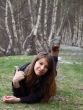 Young beautiful girl lying on the grass and shows OK hand sign