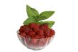 Berries of raspberry in a glass vase with the leaves of mint