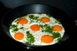 Fried eggs in a skillet.