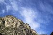 Bright blue sky and clouds above a mountain