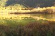An autumn lake is in mountains