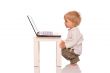 Young boy looking at a laptop