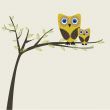 Two cute owls on the tree branch