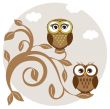 Two cute owls on the tree branch