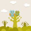 Two cute owls on the tree branch