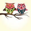 Two cute owls on the tree branch