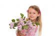 Happy little girl with lilac flowers