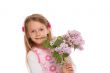 Happy little girl with lilac flowers