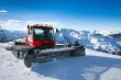 Snow-grooming machine on snow hill 