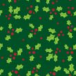 Christmas background with holly berry leaves on dark green background