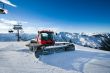 Snow-grooming machine on snow hill 