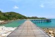 Wooden footbridge over the water near the beach 