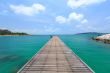 Wooden footbridge over the water near the beach 