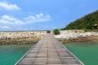 Wooden footbridge over the water near the beach 