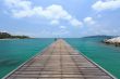 Wooden footbridge over the water near the beach 