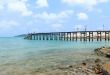 Wooden footbridge over the water near the beach 