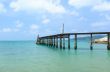 Wooden footbridge over the water near the beach 