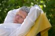 Senior woman sleeping on lounger