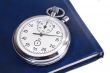 Stopwatch and the notebook on a white background