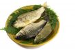Three carp on ceramic dish and greens