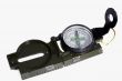 A small compass in a metal frame on a white background.
