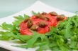 Salad with fresh tomatoes, capers and arugula