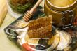Honey in pot, honeycomb and stick