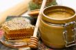 Honey in pot, honeycomb and stick