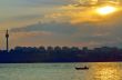 fishermen in boat at sunset